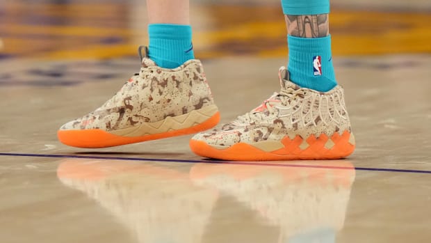View of tan and orange Puma shoes.